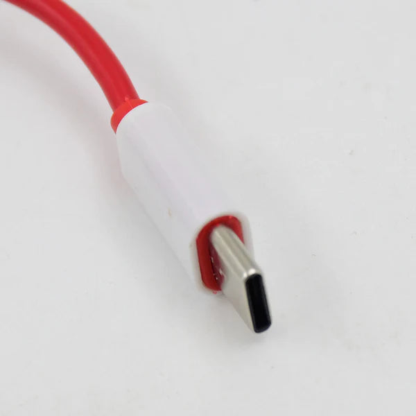 Close-up of a USB cable with red and white design on a light gray background