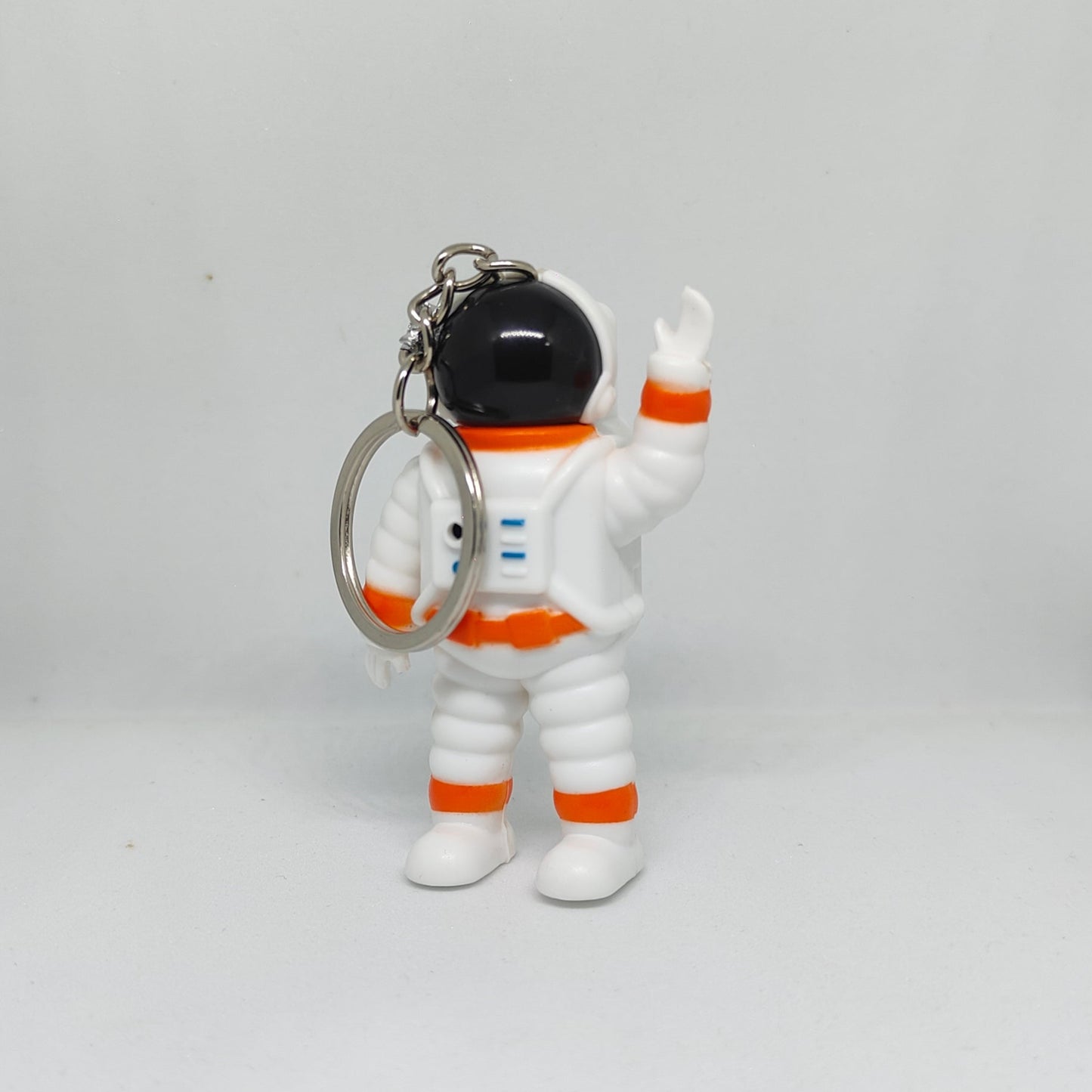 Keychain shaped like an astronaut figure on a white background