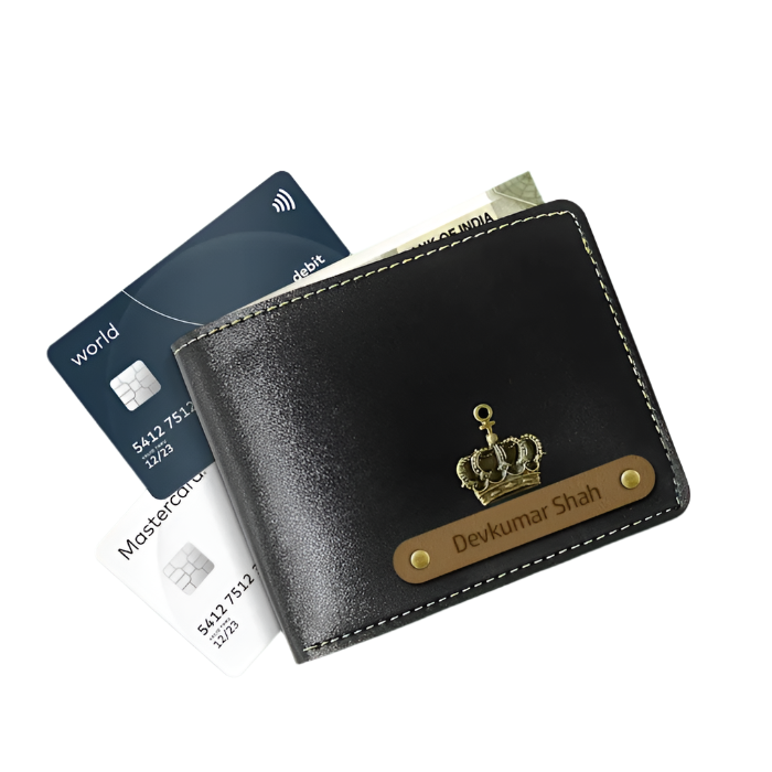 Black leather wallet with gold crown emblem and engraved name, alongside credit cards on a white background.