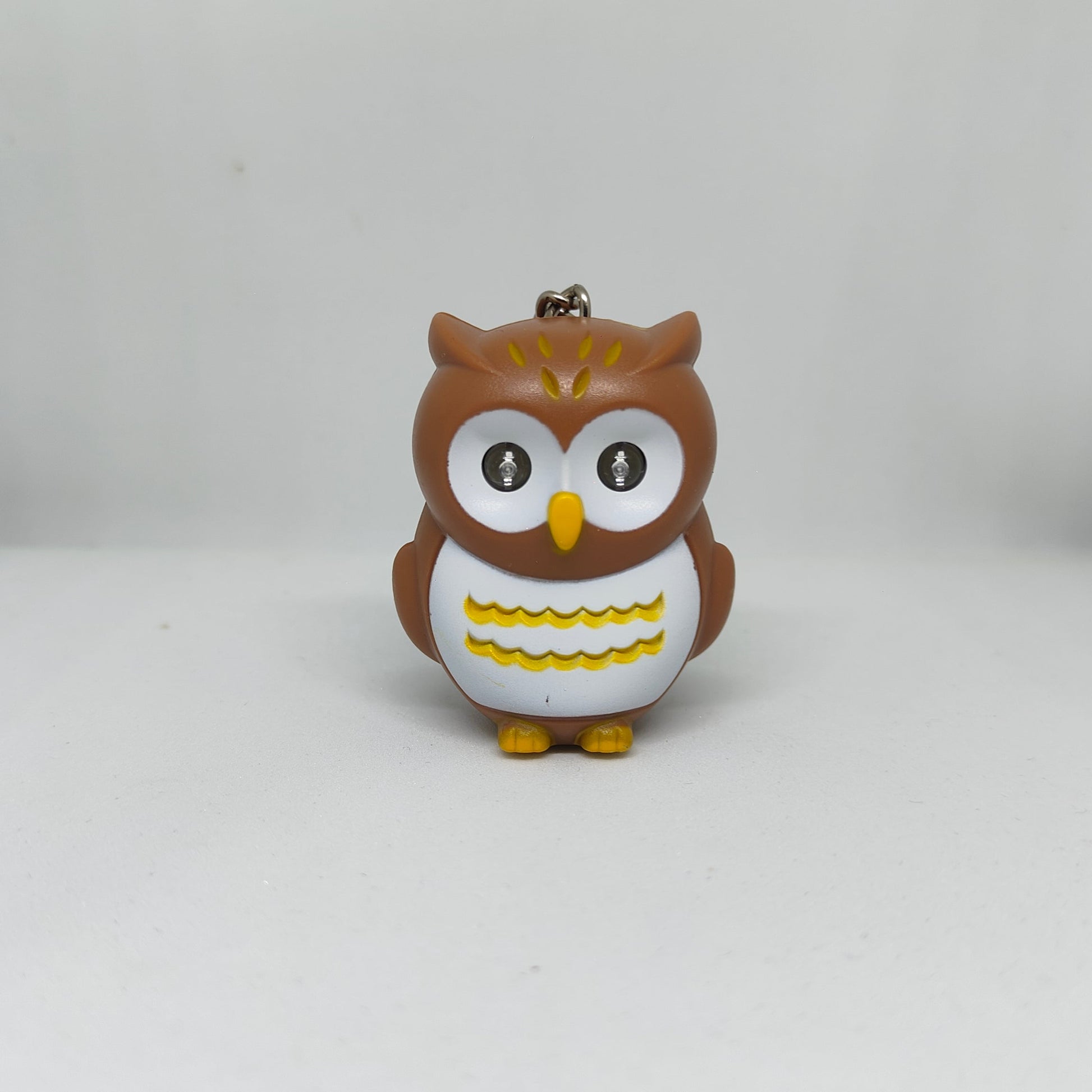 Owl-shaped keychain on a white background