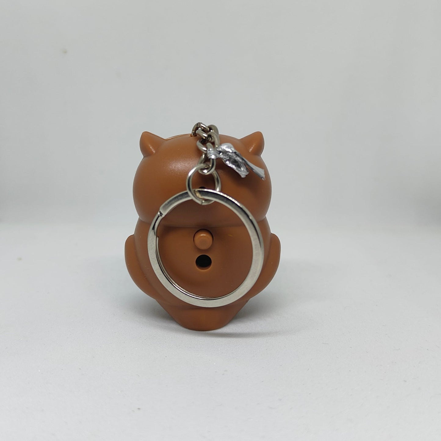 Brown owl-shaped keychain on a white background