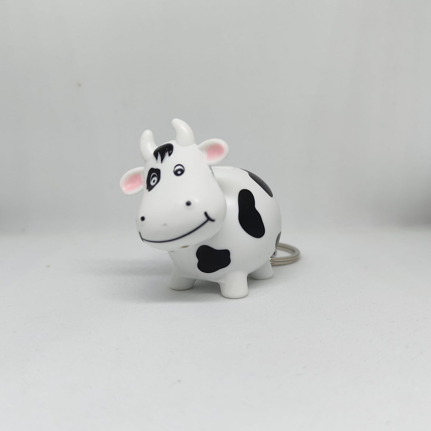 Cow-shaped toy on a gray background