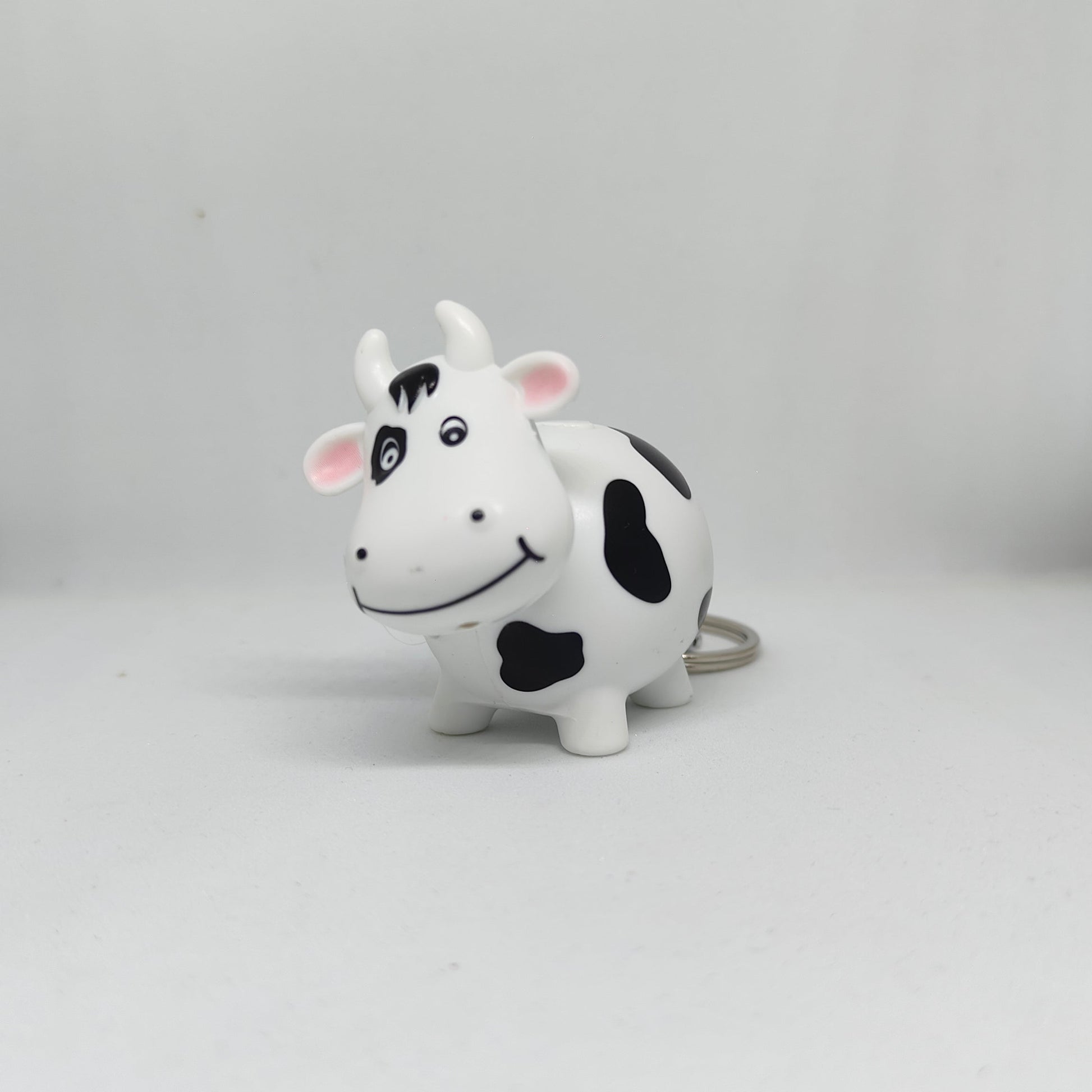 Cow-shaped toy on a gray background
