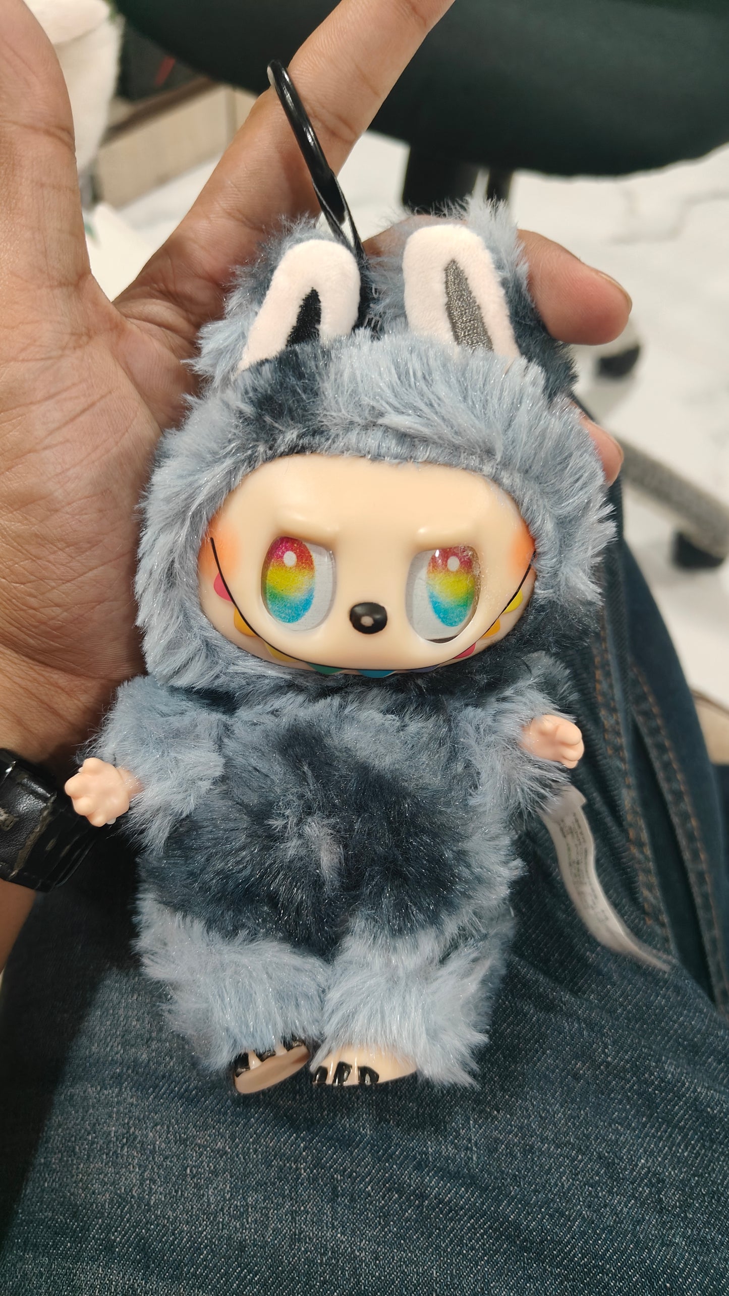 Plush toy with a character face held by a person