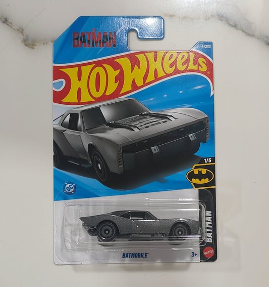 Model car in packaging on a marble surface